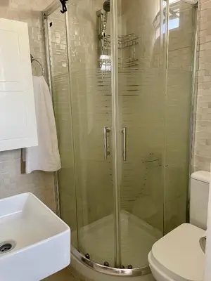 a bathroom with a shower and a toilet and a sink at Roof Garden Home in Athens