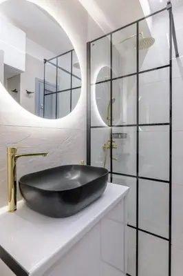 a bathroom with a black sink and a mirror at The Athens Getaway Apartment GF in Athens