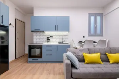 a living room with a couch and a kitchen at The Athens Getaway Apartment GF in Athens