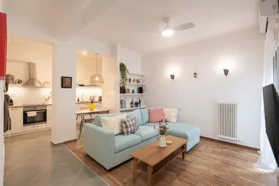 a living room with a blue couch and a table at 1BR Next to Metro Modern Comfort in Athens