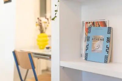 a book sitting on a counter next to a chair at 1BR Next to Metro Modern Comfort in Athens