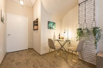 a dining room with a table and two chairs at Cozy home in the heart of Athens in Athens
