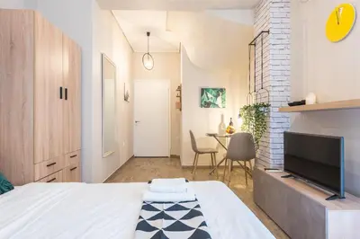 a bedroom with a bed and a tv and a table at Cozy home in the heart of Athens in Athens