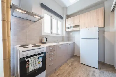 a kitchen with a stove and a white refrigerator at Cozy home in the heart of Athens in Athens