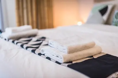 a group of towels sitting on top of a bed at Cozy home in the heart of Athens in Athens