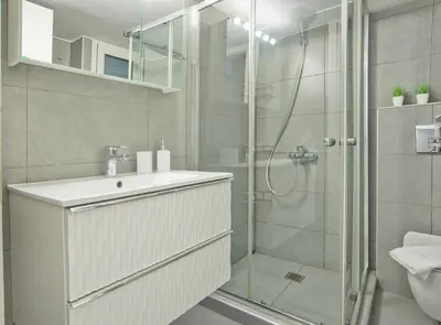 a bathroom with a shower and a sink and a toilet at Serenity in the city - Stylish 1bd Garden Flat in Athens