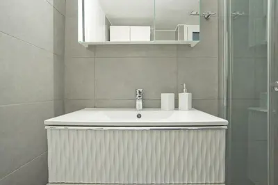 a bathroom with a white sink and a shower at Serenity in the city - Stylish 1bd Garden Flat in Athens