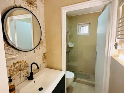 a bathroom with a sink and a mirror at Zoy's house in Athens