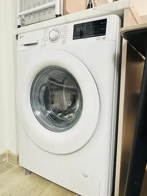 a white washing machine sitting in a kitchen at Zoy's house in Athens