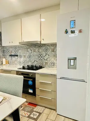 a kitchen with a white refrigerator and a table at Zoy's house in Athens