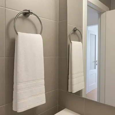 two towels hanging in a bathroom with a mirror at Saronida BEACH STUDIO in Saronida