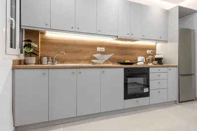 a kitchen with white cabinets and a sink at Stylish & Bright Flat Across Metro - 8' to Center in Athens