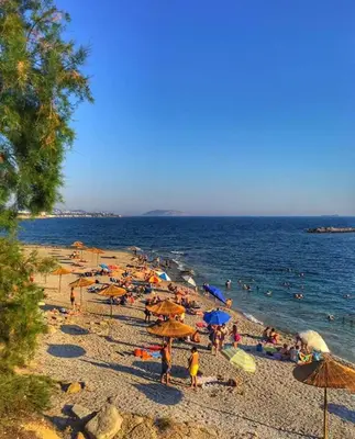 a group of people on a beach with umbrellas at Lagonissi Summer House in Lagonissi