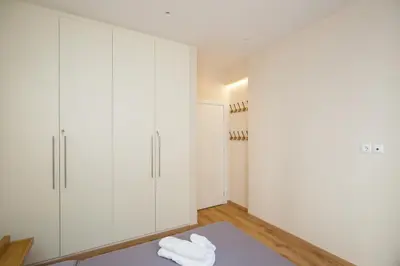 a room with white cabinets and a table with towels at Athenian Aura in Athens