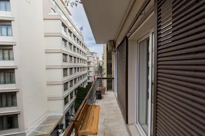 an apartment balcony with a view of a building at Athenian Aura in Athens