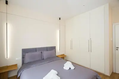a bedroom with a bed with two towels on it at Athenian Aura in Athens