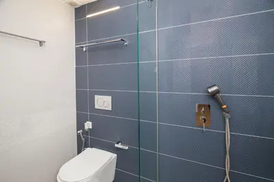 a bathroom with a toilet and a blue tiled wall at Athenian Aura in Athens