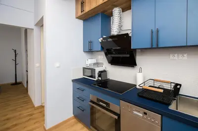 a kitchen with blue cabinets and a microwave at Athenian Aura in Athens