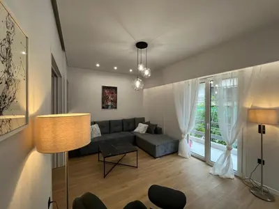 a living room with a couch and a table at 3BR Modern & Spacious apt in Athens