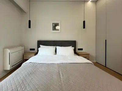 a bedroom with a large bed and a tv at 3BR Modern & Spacious apt in Athens