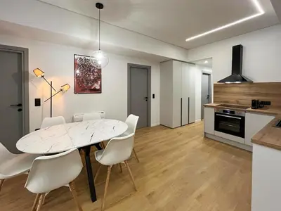 a kitchen and dining room with a white table and chairs at 3BR Modern & Spacious apt in Athens