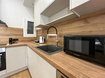a kitchen with a sink and a microwave at 3BR Modern & Spacious apt in Athens