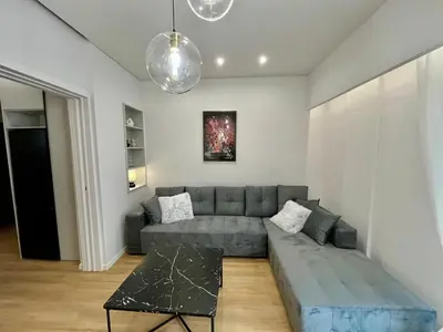 a living room with a couch and a table at 3BR Modern & Spacious apt in Athens