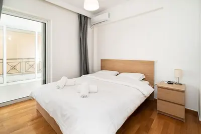 a bedroom with a large white bed with white pillows at La Casa De Los Dioses Athens in Athens
