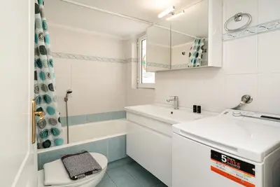 a white bathroom with a sink and a toilet at La Casa De Los Dioses Athens in Athens