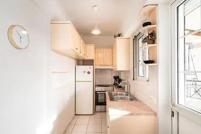 a small kitchen with a white refrigerator and a sink at La Casa De Los Dioses Athens in Athens