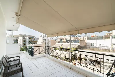 a balcony with a view of a city at La Casa De Los Dioses Athens in Athens