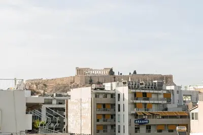 a building with a castle on top of a hill at La Casa De Los Dioses Athens in Athens