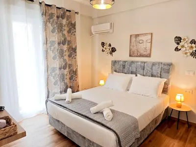 a bedroom with a large bed with white pillows at Central apartment in Athens in Athens