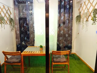 a table and two chairs in a room with a window at Central apartment in Athens in Athens