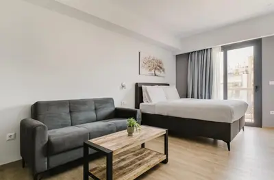 a living room with a couch and a bed at B48 Athens Dafni in Athens