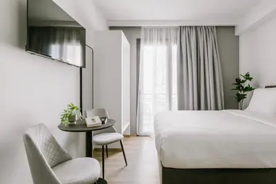 a bedroom with a bed and a chair and a table at B48 Athens Dafni in Athens