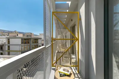 a balcony with a yellow structure on a building at B48 Athens Dafni in Athens