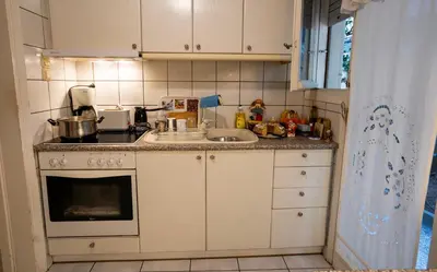 a small kitchen with a sink and a stove at 15' to Sea & Acropolis in Athens