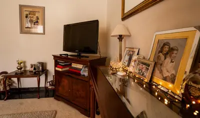 a living room with a television on a dresser at 15' to Sea & Acropolis in Athens