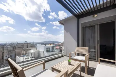 a balcony with a table and chairs and a view at Andromeda - 1 Bedroom Apt & Terrace in Athens in Athens