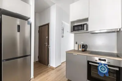 a kitchen with a stainless steel refrigerator and a microwave at Les Nuances de Bleu - 1-Bedroom & Balcony in Athens in Athens