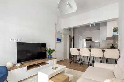 a living room with a couch and a tv at Les Nuances de Bleu - 1-Bedroom & Balcony in Athens in Athens