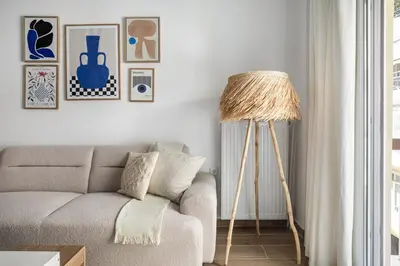 a living room with a couch and a floor lamp at Les Nuances de Bleu - 1-Bedroom & Balcony in Athens in Athens