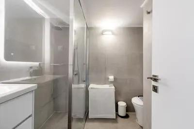a bathroom with a glass shower and a toilet at Les Nuances de Bleu - 1-Bedroom & Balcony in Athens in Athens