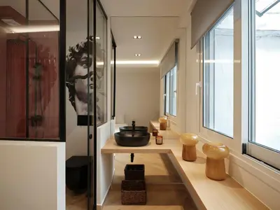 a bathroom with a table and a sink in a room at Modern Nest Studio in Syntagma in Athens