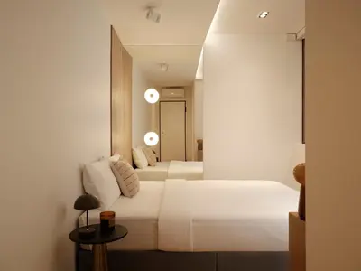 a bedroom with two white beds and a mirror at Modern Nest Studio in Syntagma in Athens