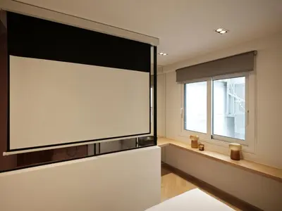 a large screen tv in a room with a window at Modern Nest Studio in Syntagma in Athens