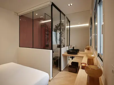 a bedroom with a bed and a bathroom with a sink at Modern Nest Studio in Syntagma in Athens