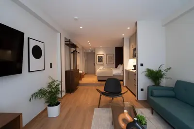 a living room with a couch and a bed at Psiri 48 Boutique Suite in Athens
