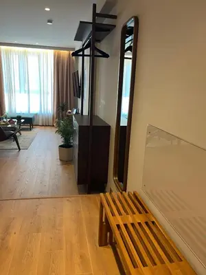 a room with a wooden bench and a mirror at Psiri 48 Boutique Suite in Athens
